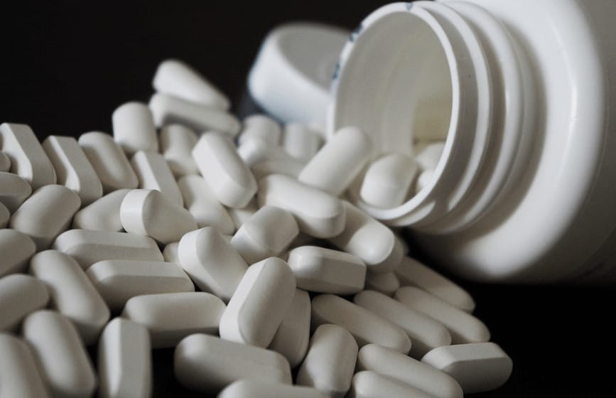 Prescription pills spilling out of medicine bottle