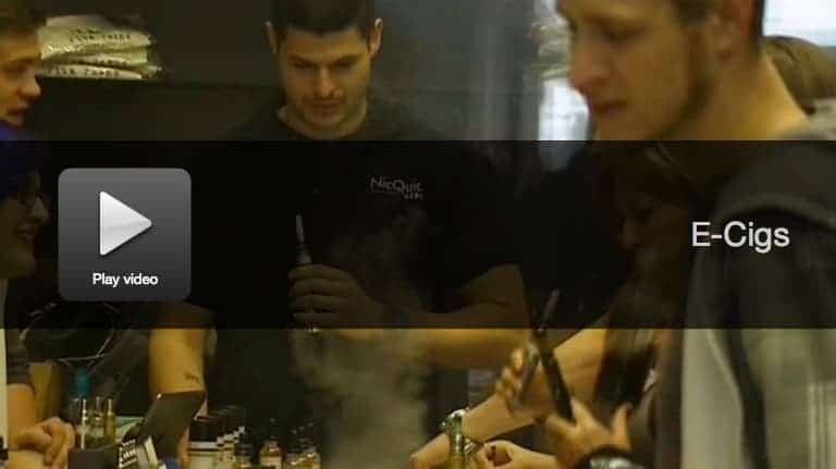 Video thumbnail showing people at a vape shop counter with e-cigarette products