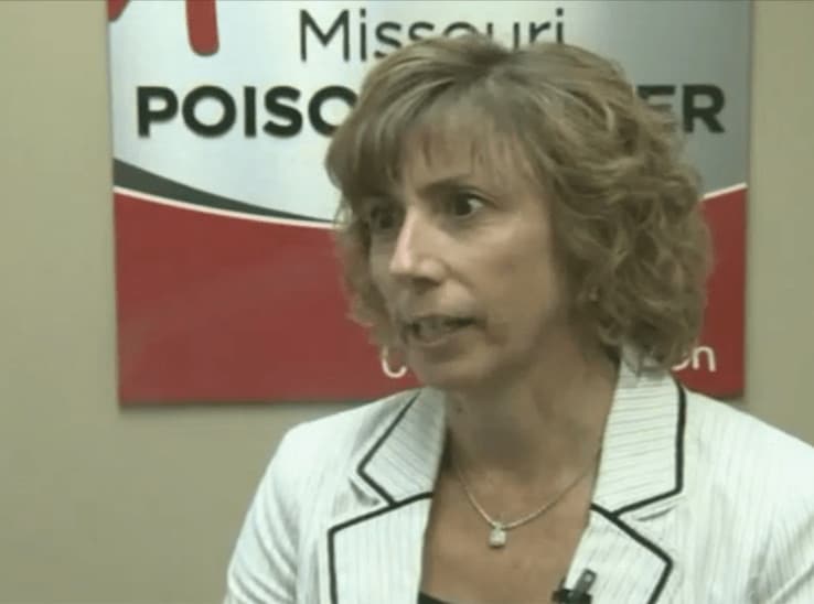 Julie Weber, director of the Missouri Poison Center, speaking in a video interview in front of a Missouri Poison Center banner.