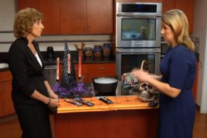 Julie Weber discusses Halloween safety items including glow sticks and face paint during a TV news segment