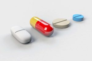 A line of different antibiotics on a white table.