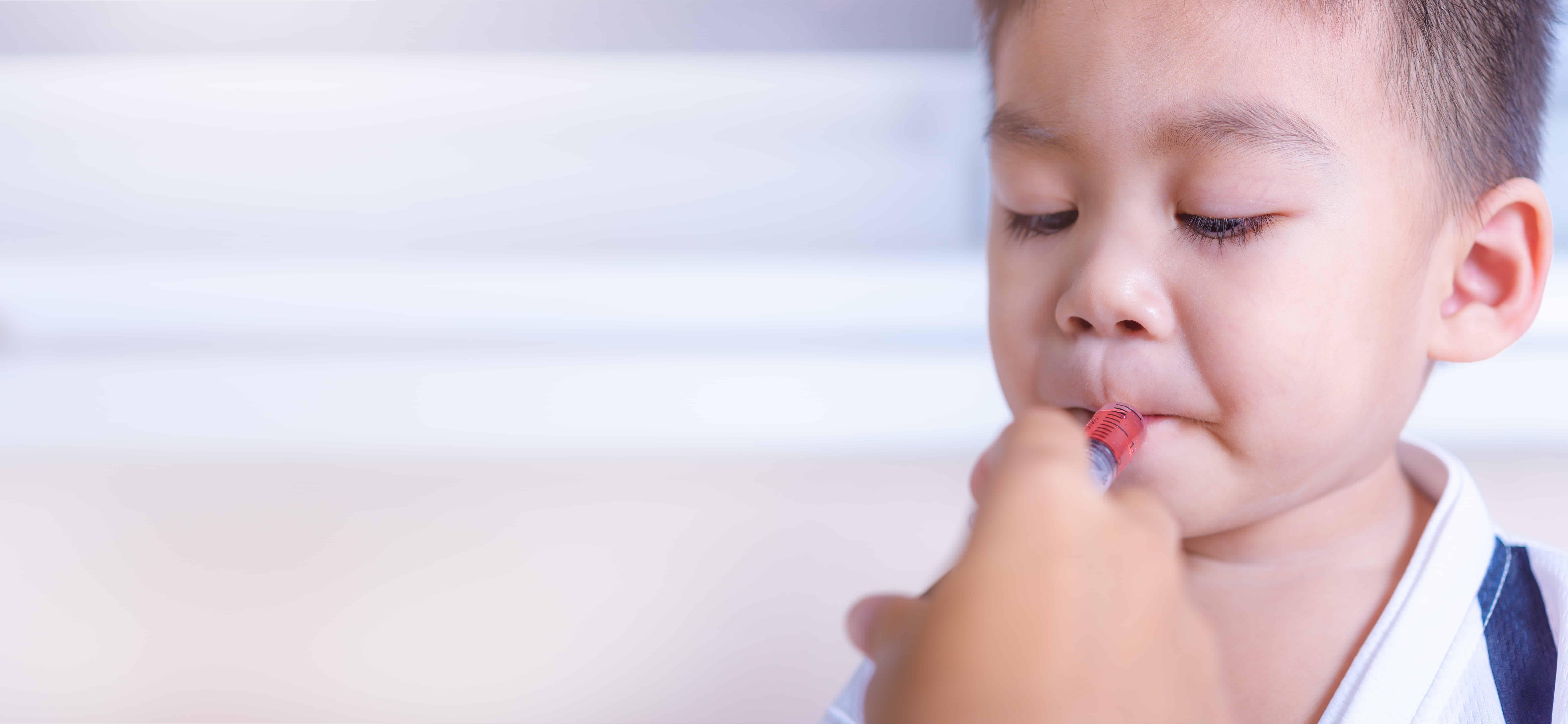 Child receiving medicine via syringe