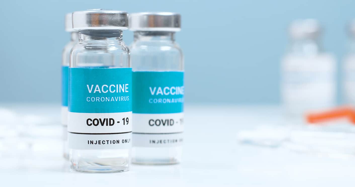 A close up of two vials of the COVID vaccine.