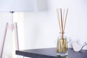 A bottle of liquid air freshener sits on a table.