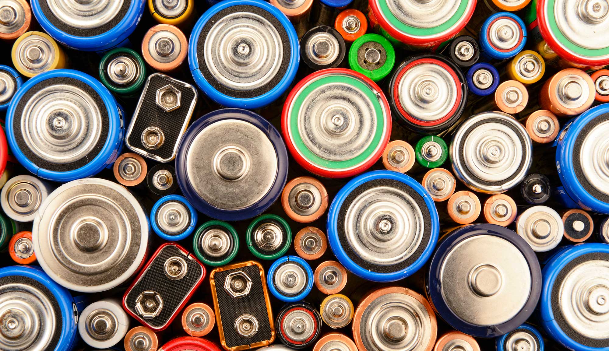 Assorted batteries of various sizes and types viewed from the top, showing colorful casings