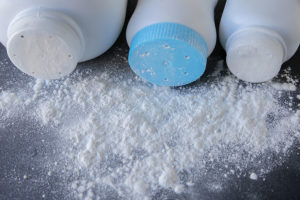 Three baby powder bottles with their contents on the table.