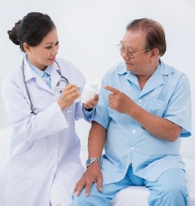 Doctor reviewing a prescription bottle with an older adult patient during a medication safety discussion.